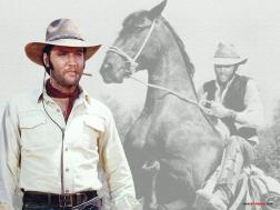 Elvis in cowboy outfit with cigar