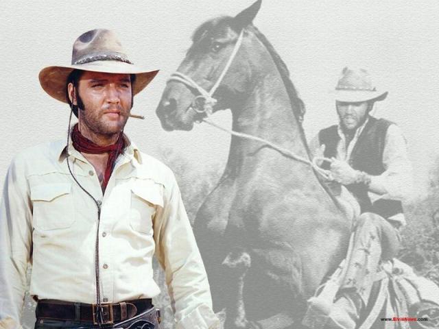 Elvis in cowboy outfit with cigar