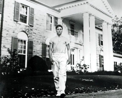 Elvis in front of his house
