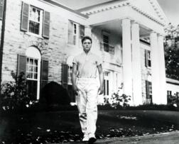 Elvis in front of his house