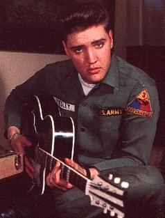 Elvis in US army uniform with guitar
