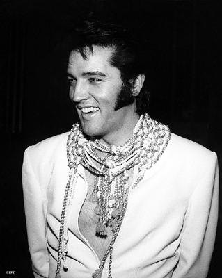 Elvis in white smiling
