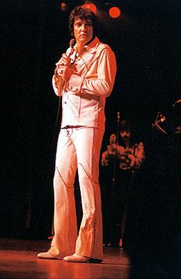 Elvis on stage in white
