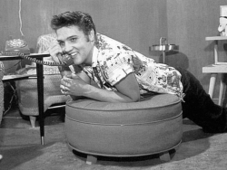 Elvis phoning in his bedroom