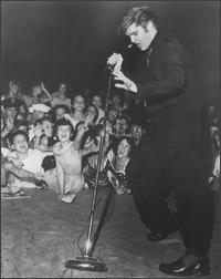 Elvis Presley dancing and singing_wearing black outfit