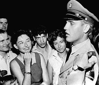 Elvis Presley in army uniform with fans
