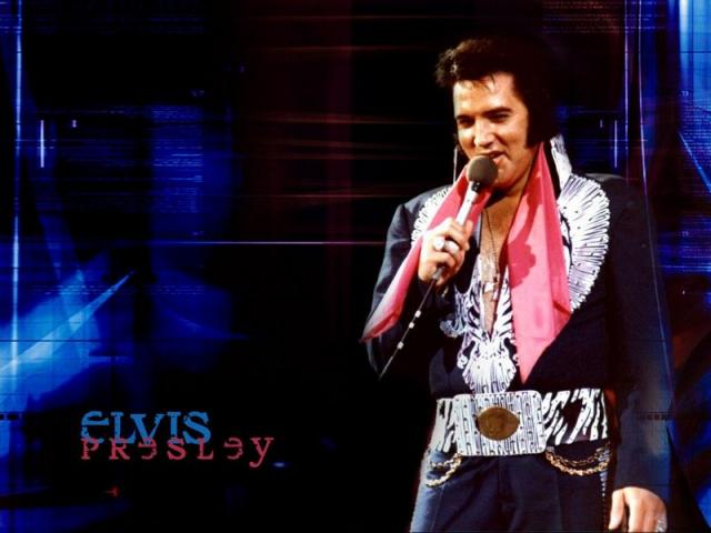 Elvis Presley in black and pink outfit
