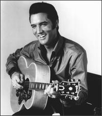 Black and white picture of Elvis Presley singing and playing guitar
