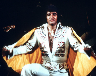 Elvis Presley in his golden and white outfit
