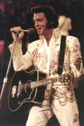 Elvis Presley on stage with his big smile