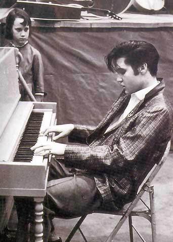 Elvis Presley playing a piano

