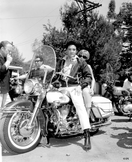 Elvis Presley setting on motobike
