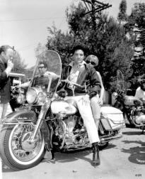 Elvis Presley setting on motobike