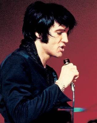 Elvis Presley singing in black shirt
