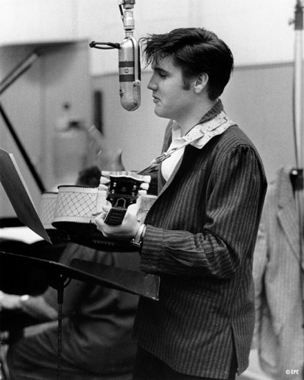 Elvis Presley singing in the studio
