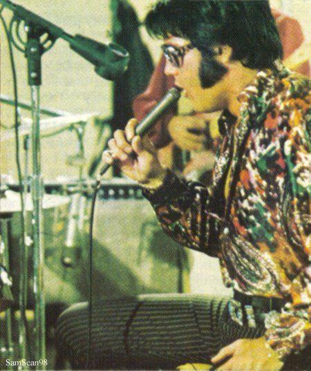 Elvis Presley singing with his colorful shirt
