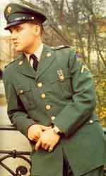 Elvis Presley wearing army uniform with hat
