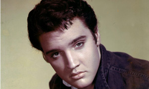 Elvis Presley wearing black jean jacket
