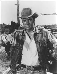 Elvis Presley wearing cowboy outfit

