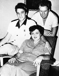 Elvis Presley with his parents in black and white picture
