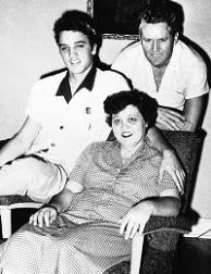 Elvis Presley with his parents in black and white picture