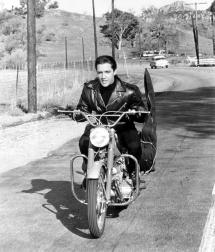 Elvis riding on motorbike in movie Roustabout
