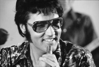 Elvis with his big glasses in black and white photo
