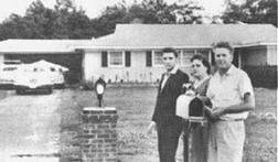 Elvis with his parents_first home bought for them