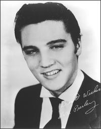 white and black picture of Elvis Presley smiling
